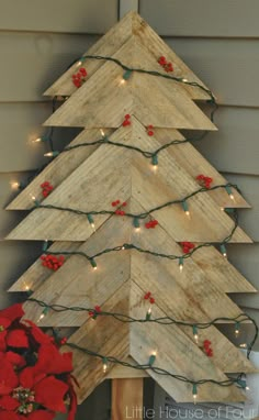 a wooden christmas tree with lights on it