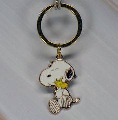 a keychain with a cartoon character on it's side and a gold colored metal ring