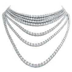 A statement masterpiece. A stunning tennis necklace features a collection of Diamonds , each more mesmerizing than the last. The array of diamonds creates a sparkling and radiant piece of jewelry that is sure to catch the eye and make a bold statement. The elegant style exudes sophistication and grace , making it the perfect accessory for any formal occasion. Elevate your collection with this extraordinary piece; it is an epitome of luxury and elegance. A true masterpiece, it embodies sophistica Italian Jewelry Designers, Contemporary Necklace, 18k Gold Necklace, Italian Jewelry, Emerald Necklace, Tennis Necklace, Modern Necklaces, Diamonds And Gold, Multi Strand Necklace