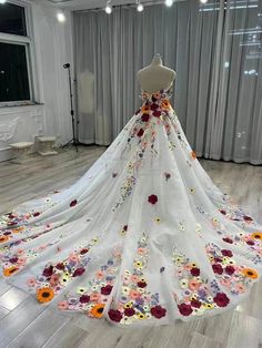 a white wedding dress with flowers on it