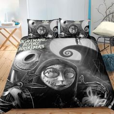 a bed covered in black and white comforter covers with an image of two people