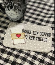 a black and white checkered table cloth with a drink on it