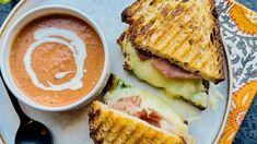 grilled cheese and tomato soup on toasted bread with a spoon next to it