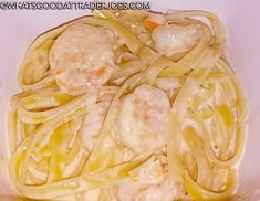 pasta with meatballs and sauce in a white bowl