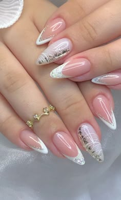 a woman's nails with white and pink designs on them