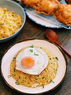 fried egg on top of rice in a bowl