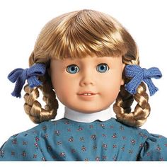 a close up of a doll with blonde hair and blue eyes wearing two braids