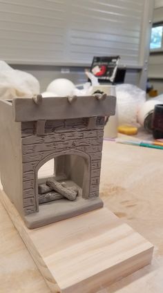 a clay model of a fireplace on a table