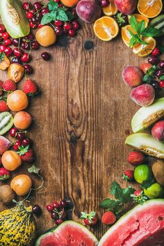 various fruits and vegetables arranged in the shape of a rectangle on a wooden surface