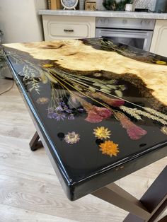 a black table with flowers painted on it