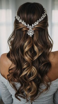 a woman with long hair wearing a bridal headpiece in the shape of a flower