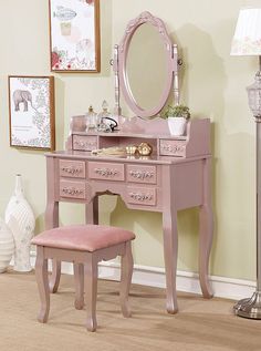 a pink vanity with mirror, stool and lamp