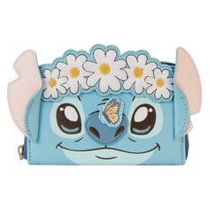 a blue purse with flowers and a butterfly on the front, sitting on top of it