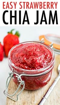 strawberry chia jam in a glass jar on a cutting board