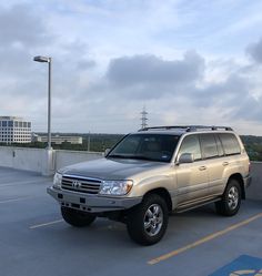 a silver suv parked in a parking lot