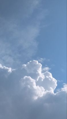 the plane is flying high in the blue sky with white clouds behind it and an airplane on the right side