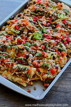 a tray filled with nachos covered in toppings