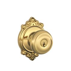 an antique style door knob with ornate design on the front and side, shown in polished brass