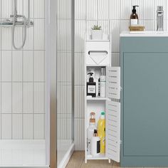 an open cabinet in the corner of a bathroom next to a sink and shower stall