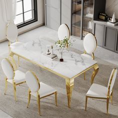 a marble dining table with white chairs and gold trimmings on the legs, in front of a large window