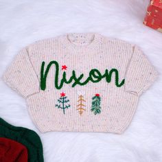 Hand Embroidered Baby Name  Christmas Sweater for Baby Boys and Toddler Boys, Baby Toddler Custom Holiday Sweater, Christmas Baby Outfit Welcome your little one into the world with our charming personalized baby name sweater, hand embroidered with love and care. This cozy and stylish announcement baby sweater is the perfect birthday gift or newborn gift, crafted from the softest wool to keep your baby warm and comfortable. Key Features: Personalized Oversized Christmas Baby Toddler Name Sweater Baby Christmas Outfit Boy, Diy Christmas Sweater, Baby Boy Christmas Outfit, Boys Christmas Outfits, Kids Christmas Sweaters, Name Christmas, Baby Christmas Outfit, Baby Sweater, Baby Outfit