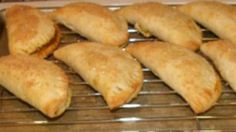 several pastries sitting on top of a metal rack