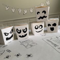 four halloween boxes with faces drawn on them