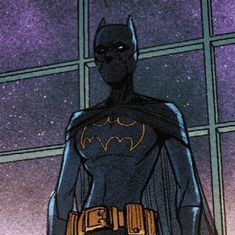 a batman standing in front of a window