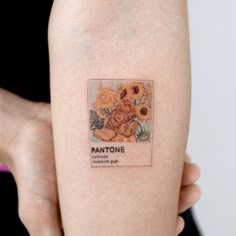 a woman's arm with a tattoo on it that reads pantonee and has sunflowers