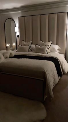 a large bed with white sheets and pillows