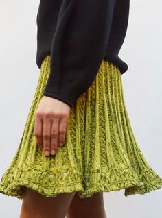 Made in France in a soft, feminine knit that defines its lovely herringbones, this short knit skirt is characterized by a sublime fringed edge that moves gracefully in a flared cut that unfurls from a wide scalloped waistband. In a "canola-deep black" colorway, a subtle yellow highlighted by a touch of black, this fine knit skirt can be easily paired with the soft "steel", "deep black" or "indigo" colors from the Molli collection. the model is 1m78 tall and wears a size s. Crinoline Dress, Herringbone Knit, Short Black Skirt, Indigo Colour, Soft Feminine, Deep Black, Happy Colors, Short Skirt, Knit Skirt