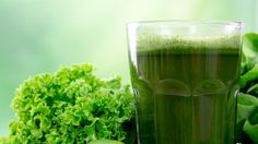 a green juice with broccoli, celery and lime on the side