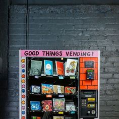 a vending machine sitting next to a brick wall