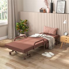 a hospital bed sitting on top of a hard wood floor next to a table with flowers