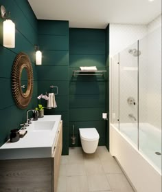 a modern bathroom with green walls and white fixtures, along with a large mirror on the wall