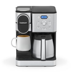 a coffee maker with a cup next to it