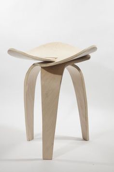 a wooden stool with curved legs on a white background