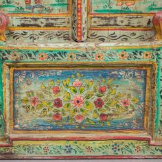 an ornate painted cabinet with flowers and birds on it