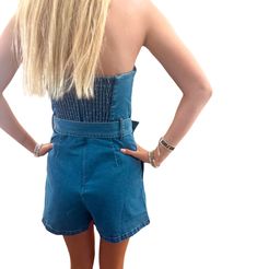 Introducing the Josie Denim Romper Embrace effortless style with the Josie Denim Romper, the ultimate choice for your summer adventures. This chic strapless design features a flattering belted waist that accentuates your silhouette, making it a must-have piece for any fashion-forward wardrobe. Key Features: Strapless Style: Stay cool and stylish during warm summer days. Belted Design: Highlights your waist for a tailored look. Durable Denim Fabric: Made to withstand all your summer escapades whi Belted Medium Wash Bottoms For Summer, Trendy Strapless Jumpsuit For Summer, Medium Wash Overall Jumpsuits And Rompers For Day Out, Summer Cotton Strapless Fitted Jumpsuit, Medium Wash Overall Jumpsuit For Day Out, Trendy Medium Wash Jumpsuits And Rompers For Day Out, Chic Denim Shortalls For Summer, Summer Denim Belted Bottoms, Chic Denim Overall Shortalls