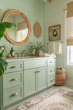 a bathroom with green cabinets and a rug on the floor in front of a window