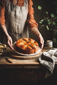 a person is cutting into a cake on a wooden table with bananas in the background