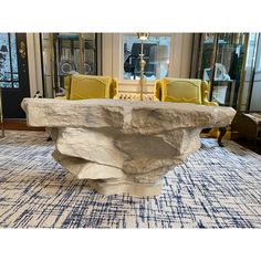 a large stone table sitting on top of a rug