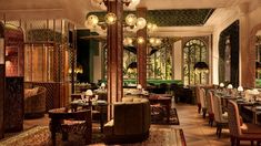 a dining room filled with lots of tables and chairs next to tall lamps hanging from the ceiling