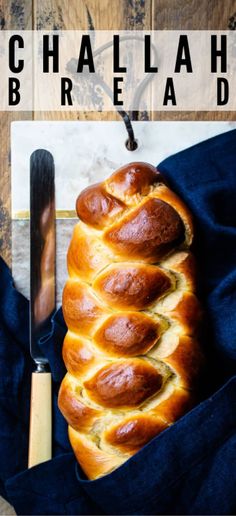 a loaf of bread sitting on top of a blue cloth next to a knife