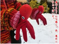 two red octopus stuffed animals in the snow