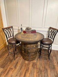 a table with two stools and a book on it