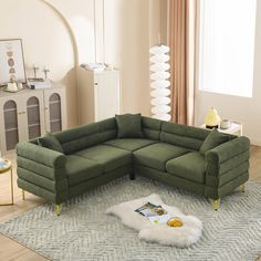 a green sectional sofa sitting on top of a rug