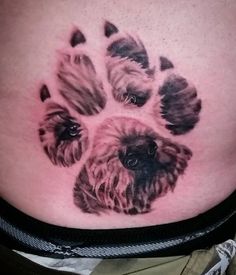 a dog paw tattoo on the stomach