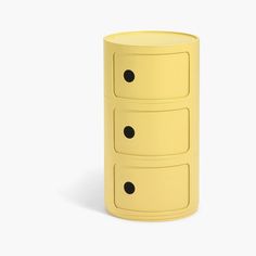 a yellow three - drawered cabinet with black dots on the top and bottom drawers