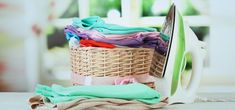 an ironing board sitting on top of a pile of clothes